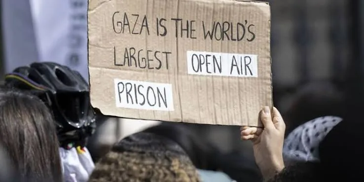 Protest sign reading Gaza is the world's largest open air prison